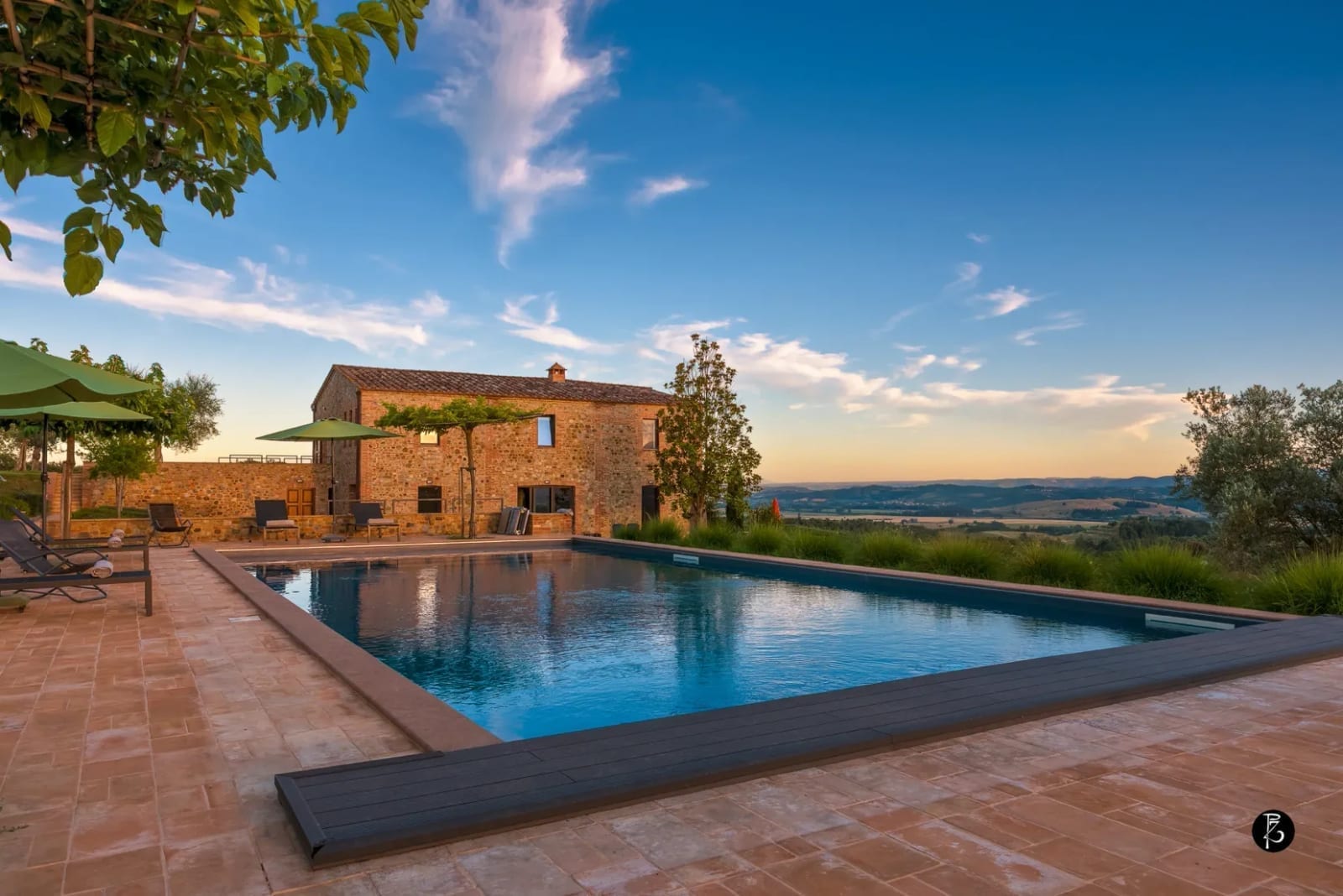 Luce dorata al tramonto — Colline umbre — Piscina a sfioro — Casale rurale — Facciata in pietra — fotografia professionale Paolo Zuchegna